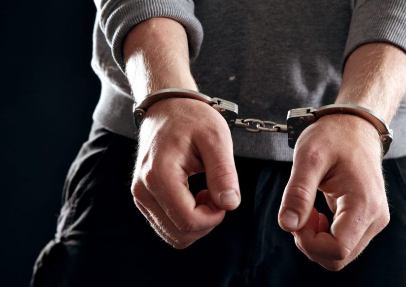 Offender with his hands in handcuffs